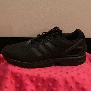 Black Adidas athletic shoes